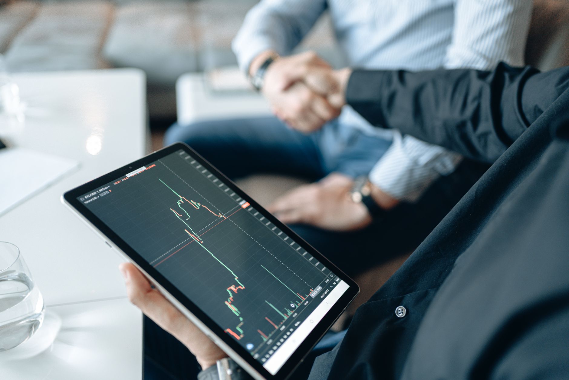 business people reading financial news on tablet