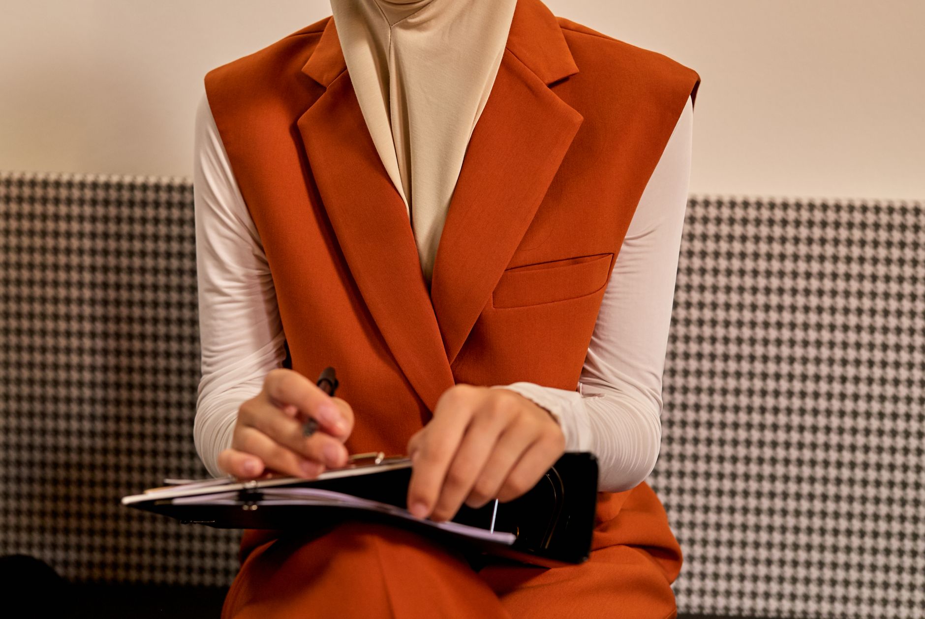 elegant woman relaxing, while a concierge takes care of tasks