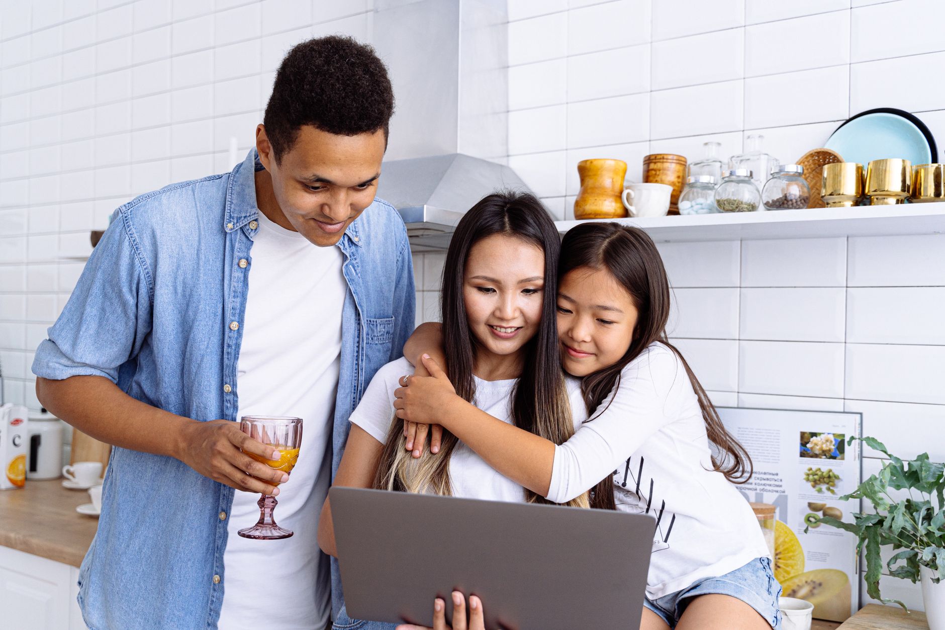 family looking at computer screen together
